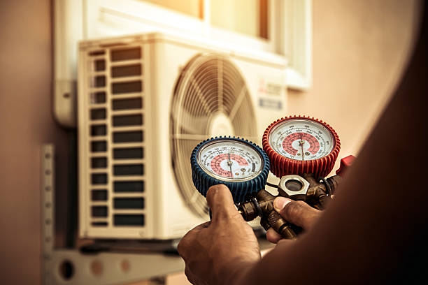 Professional Air Conditioning Service technician working in Camanche, IA